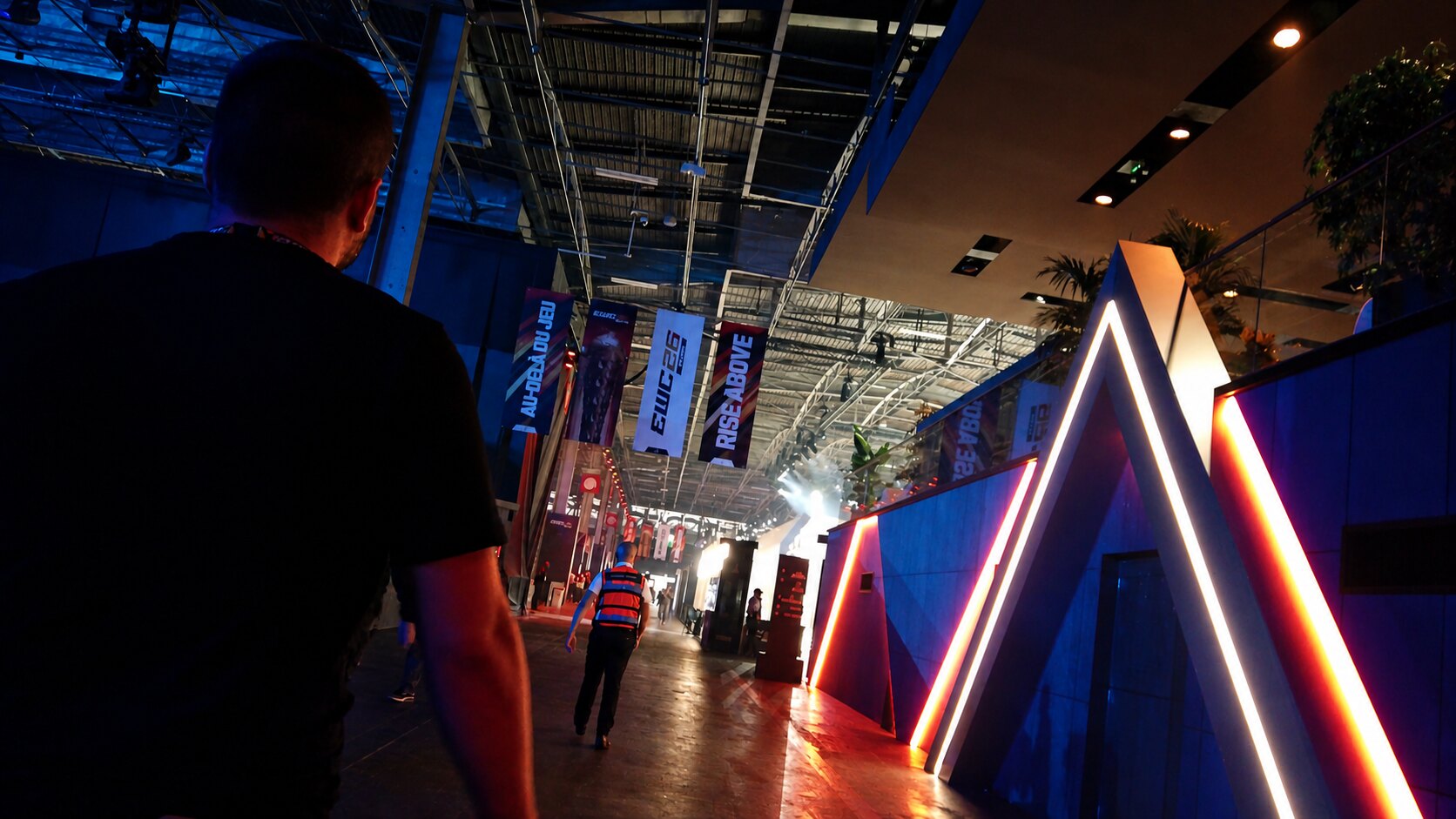Walking through the Esports World Cup 2026 venue in Paris beneath EWC banners and illuminated event architecture.