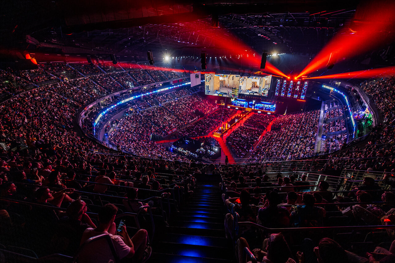 A full arena view of IEM Cologne 2024 under red stage lighting.